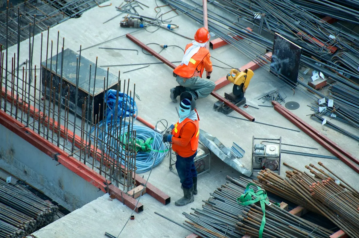 Civil engineers on modern reinforced concrete construction site